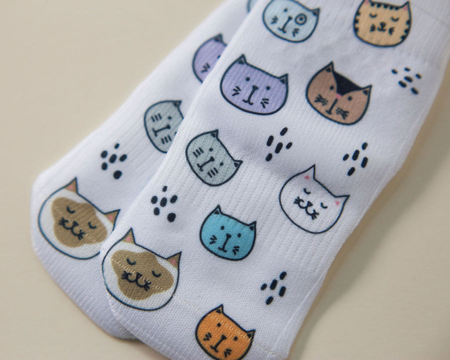 Meow kids socks: white socks with colorful cat faces and paw prints. Squid Socks, the brand seen on Shark Tank.