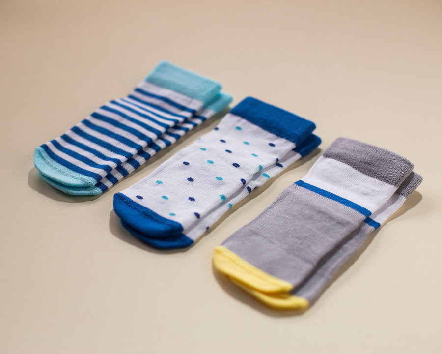 Cruz kids socks: three blue striped, dotted and gray color-block socks. Squid Socks, the brand seen on Shark Tank.