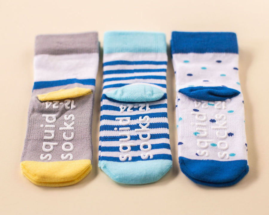 Cruz kids socks: three patterned socks showing branded sole grips. Squid Socks, the brand seen on Shark Tank.