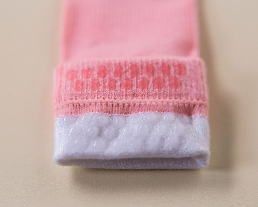Caroline kids socks: close-up of pink grip dots inside a folded cuff. Squid Socks, the brand seen on Shark Tank.