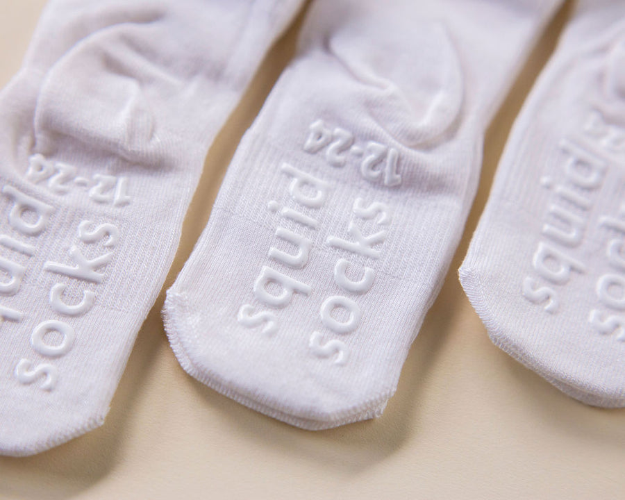 Comfort kids socks: white socks showing branded sole grips. Squid Socks, the brand seen on Shark Tank.