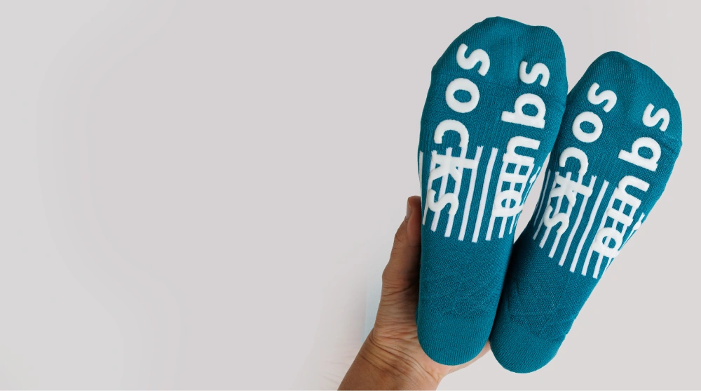 Turquoise adult socks showing silicone bottom grip