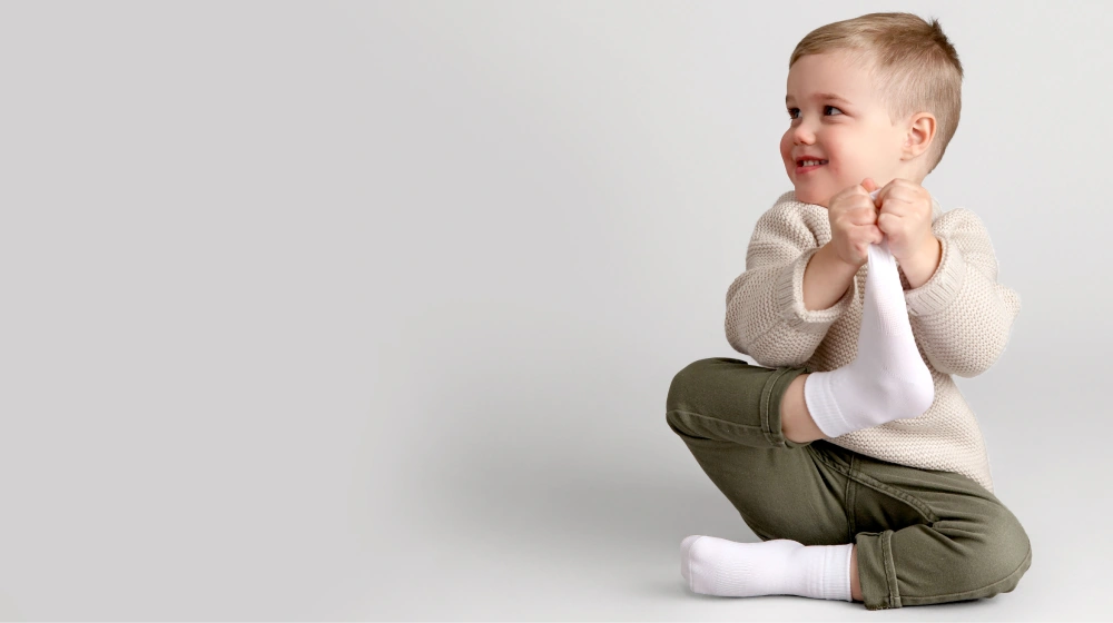Baby wearing white Squid Socks